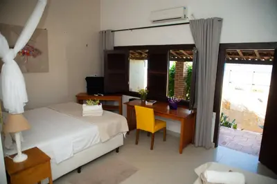 Uma cama ou camas num quarto em Pousada Vila Canoa