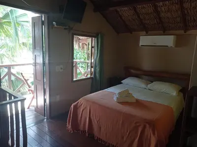 Uma cama ou camas num quarto em Pousada Chale Creoulo