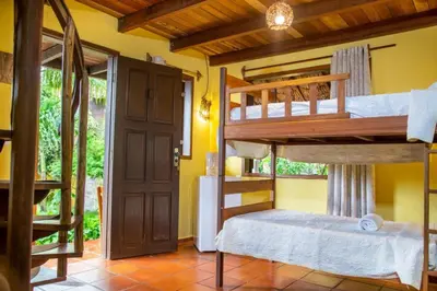 Uma cama ou camas num quarto em Pousada Chale Creoulo
