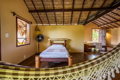 Uma cama ou camas num quarto em Pousada Chale Creoulo