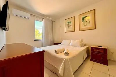 Uma televisão e/ou sistema de entretenimento em Apartamentos e Suítes na Praia