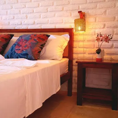 Uma cama ou camas num quarto em Suítes Bosque de Flecheiras