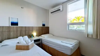 Uma cama ou camas num quarto em Apartamento pé na areia com jacuzzi - 3 quartos - 7 hóspedes - Beach Park